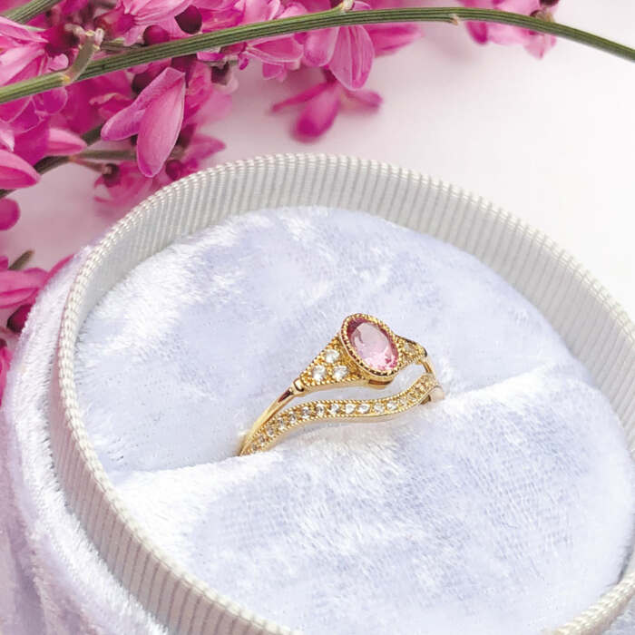 La bague LILIBETH courbe en or jaune 18 carats et saphirs blancs et la bague BÉATRICE sertie d'une tourmaline rose et de saphirs blancs en or jaune 18 carats Fairmined